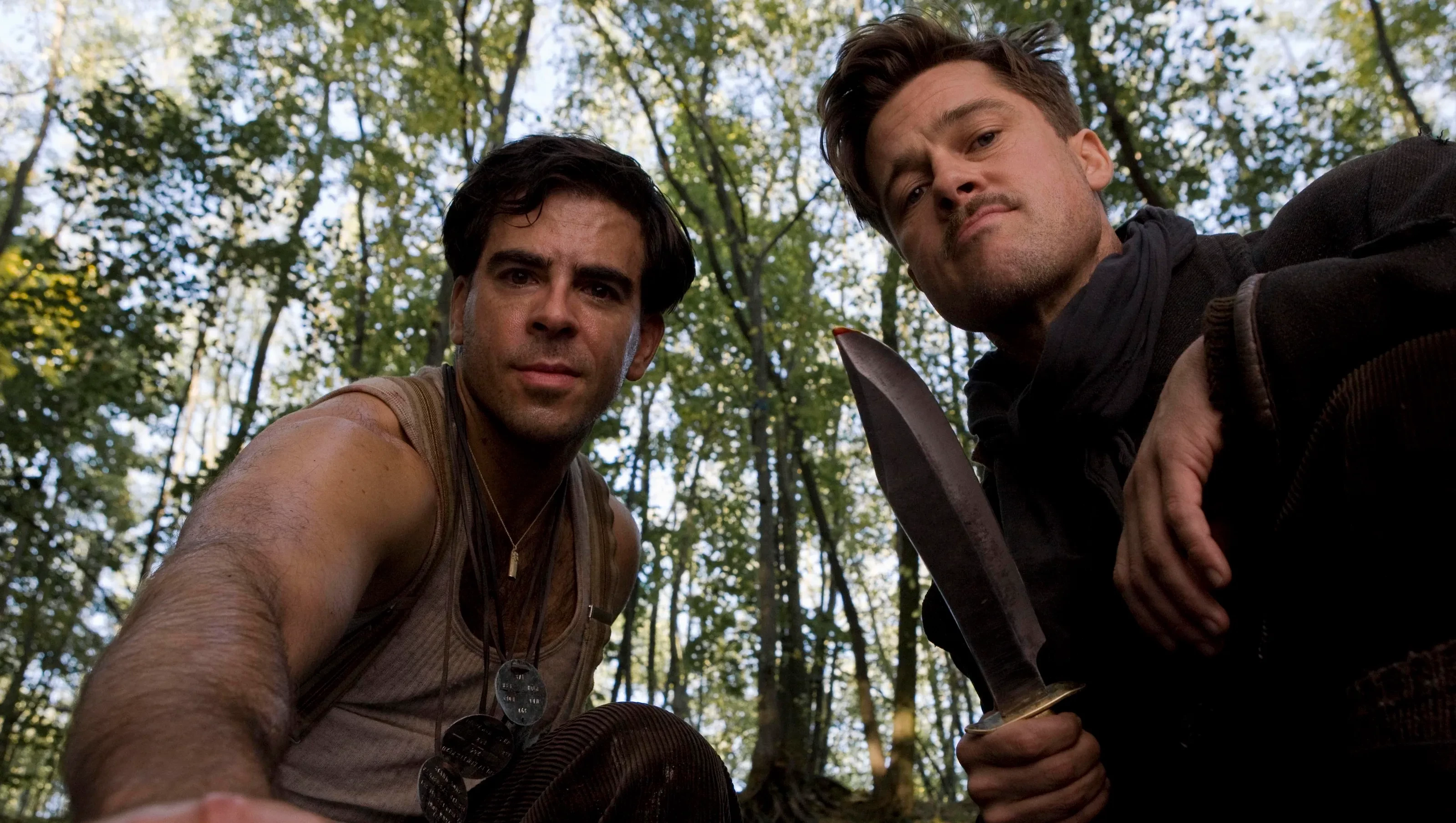 Aldo and "the Bear Jew" from Inglorious Basterds, leaning in to appreciate their work after carving a swastika into a Nazi's forehead.