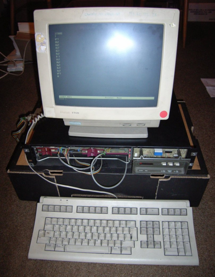 The LSI-11 A large desktop PC sized black machine with some telltale purple card pulls showing connected to a VT420 monitor. The screen has text on it, but it's just "hello there" typed one letter at a time to the pdp's "@" prompt.