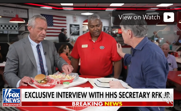 RFK Jr. being served French fries during a visit to Shake Shake while being interviewed on Fox News. 
