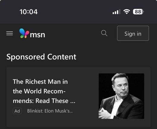 A dark-themed web page displaying sponsored content. The focus is on an advertisement titled "The Richest Man in the World Recommends: Read These..." accompanied by a black and white image of a man in a suit. The interface includes a logo