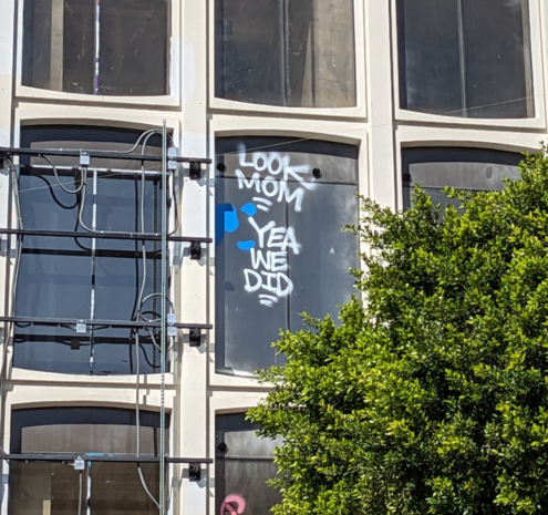 Graffiti on a third story window: Look Mom / Yea we did