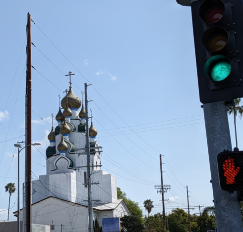Ornate onion turrets on a fantastical cathedral framed by power lines.