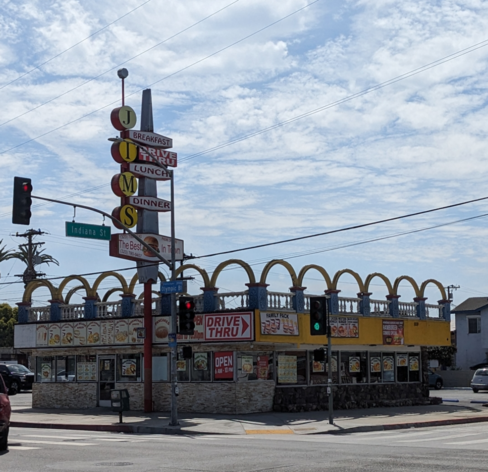 Burger stand with arches and a classic sign