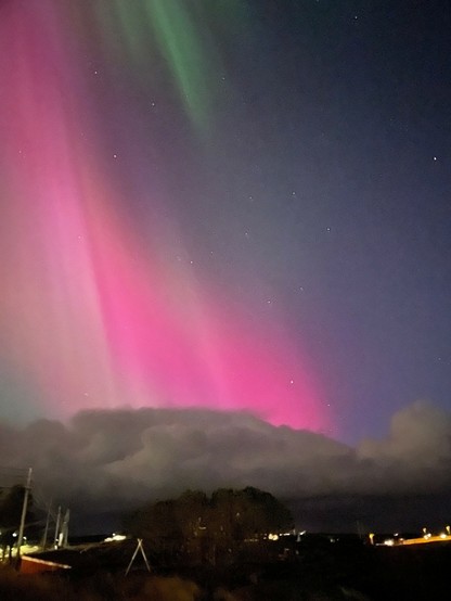Colo image of the Aurora Borealis - the Northern Lights - over Mausund, Trondelag County, Norway, January, 2025