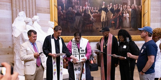 A group of people in liturgical garb in the capitol rotunda.