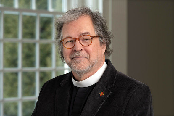 A man in a clerical collar.