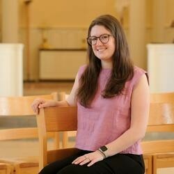 A woman sitting in a chair, smiling.