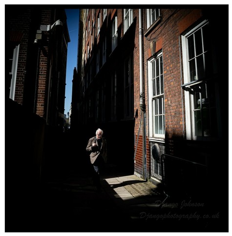 A lone figure captured during a lunchtime stroll around Westminster in London. It was summer and the light was very harsh,so went looking for interesting light/shadow transitions. Canon EOS 6D &amp; EF 28-80mm f/2.8-4.0L
