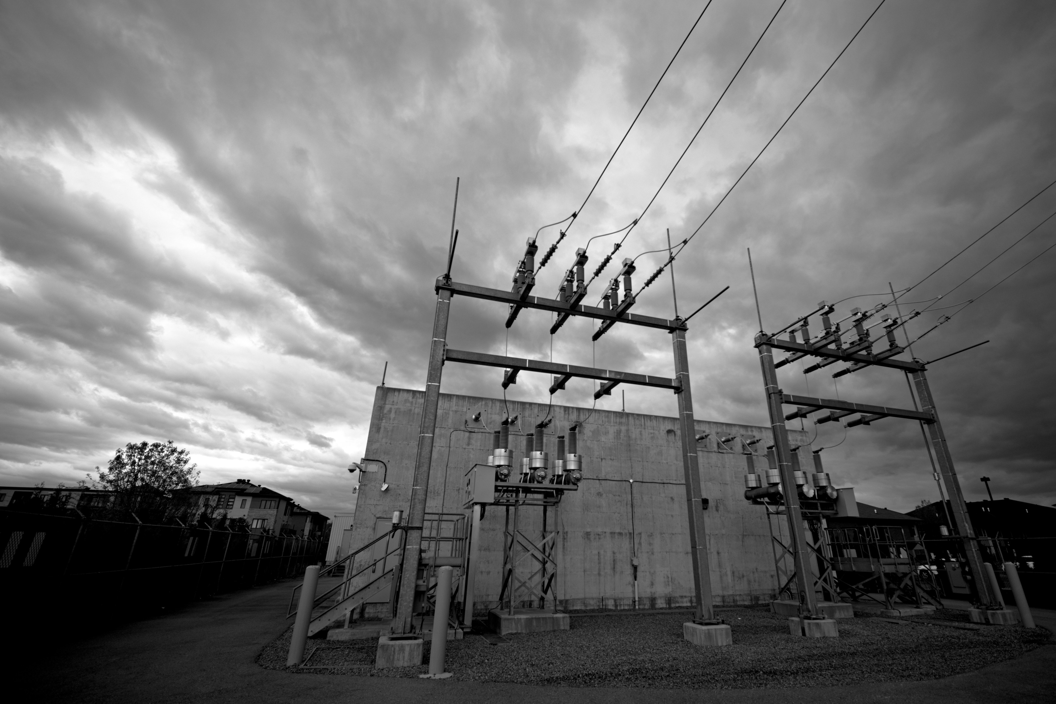 An electrical substation under storm-promising clouds