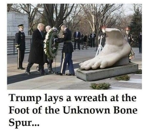 Manipulated photo at a military cemetery of convicted felon Donald J Trump accompanied by uniformed armed services members as he holds a large wreath.
Caption reads,"Trump lays wreath at the Foot of the Unknown Bibe Spur."