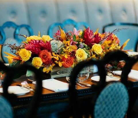 A table set with brightly colored flowers.
