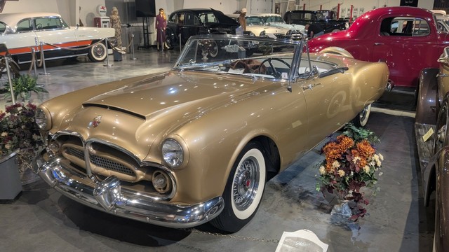 A gold painted convertible roadster.