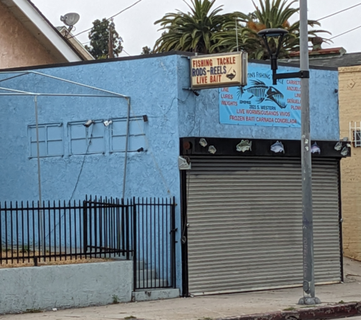 Cinder block building with a bait and tackle sign