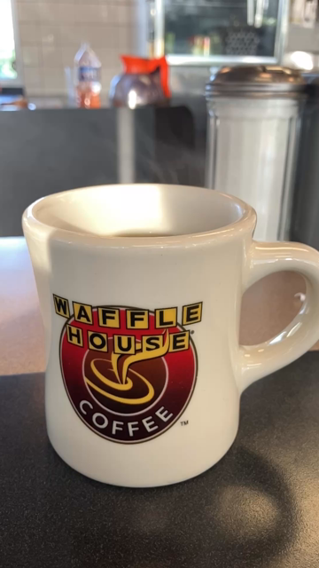A slow motion video of a hot cup of coffee, steaming visibly in the morning light. The mug shows the Waffle House logo. 