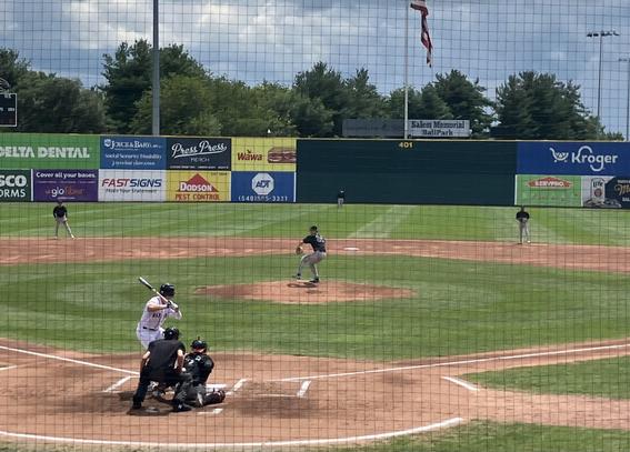 A baseball game in progress at Salem Memorial Ballpark, featuring a Salem Red Sox batter in white attire at home plate, a Carolina Mudcats pitcher in gray on the mound, and players positioned in the outfield. There are advertisements visible on the outfield fence and a flag flying
