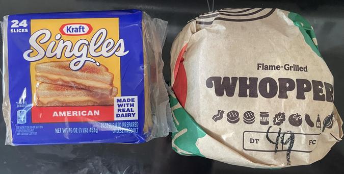 A picture of a 24 pack of Kraft Singles American cheese slices, and a wrapped Whopper burger without cheese.