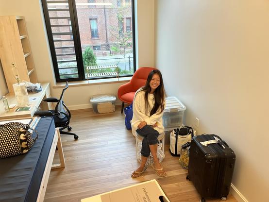 A student sitting in a dorm room.