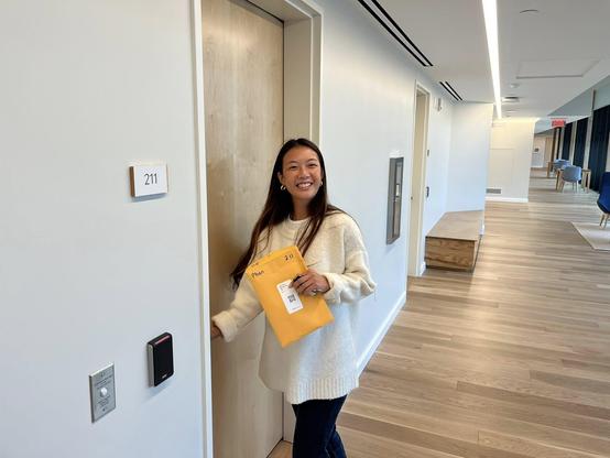 A smiling student entering a room.