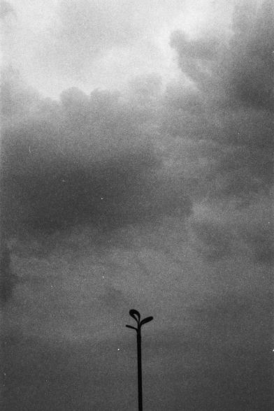 Lucky Lucky SHD 400 (FF)

English Alt Text:
A black-and-white image of a cloudy sky with a single streetlight pole in the foreground. The pole has two lamps branching out at the top, forming a Y-shape. The sky is filled with dense, dark clouds, suggesting an impending storm or overcast weather. The minimalistic composition emphasizes the isolation of the streetlight against the dramatic sky, creating a somber and contemplative mood. The image captures the quiet tension of a moment before rain.
…