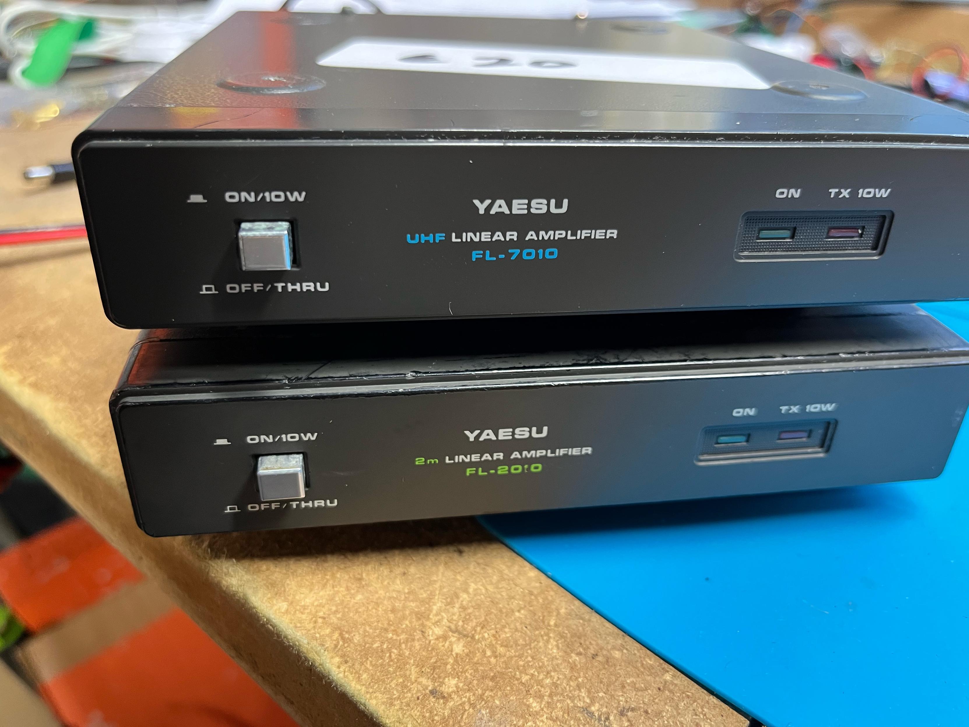 Two small Yaesu linear amplifiers stacked on the workbench.