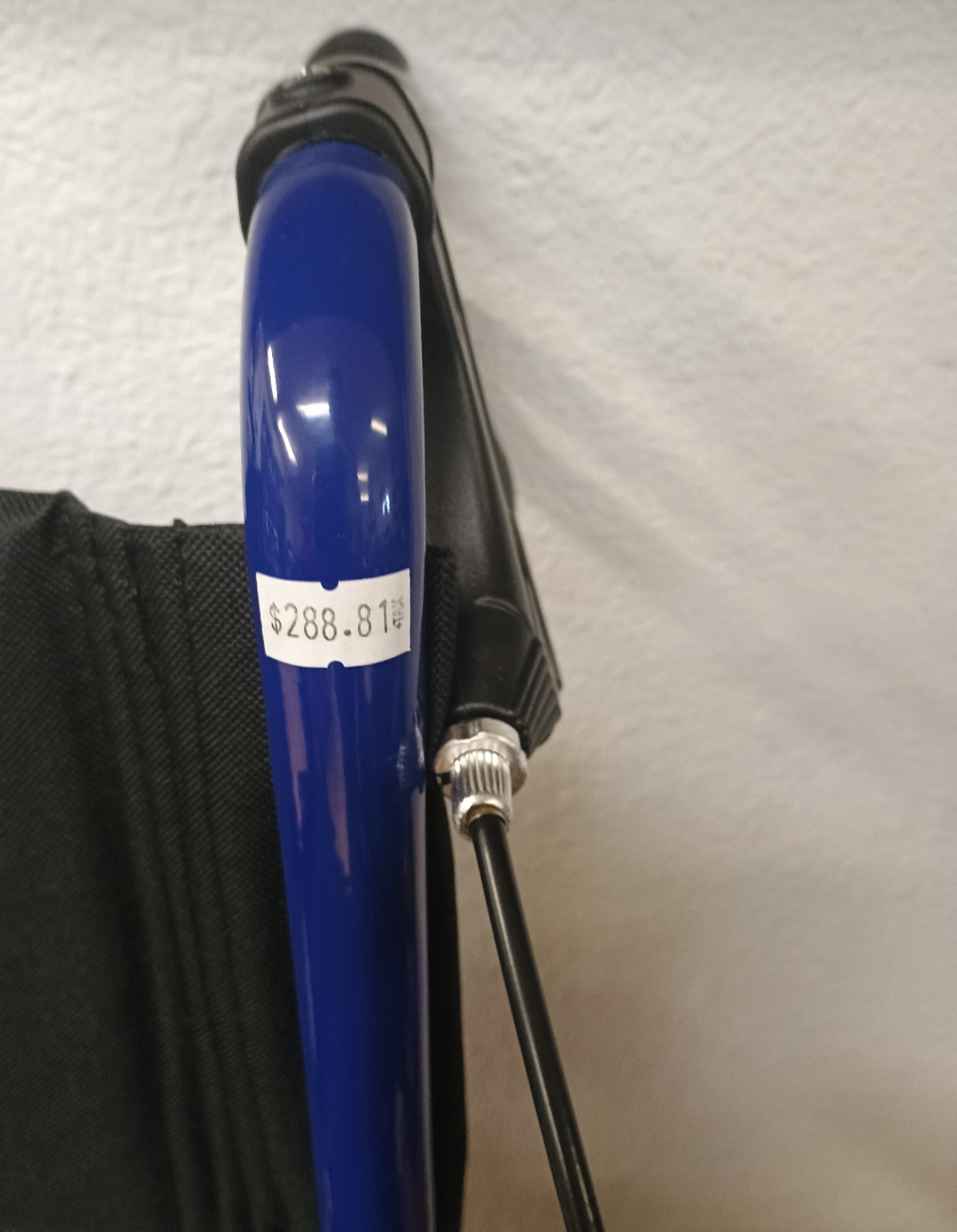 A blue wheelchair with price label $288.81