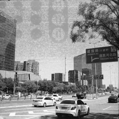 Ilford HP5 Plus 400 (6x6)

English Alt Text:
A vibrant urban street scene with multiple lanes of traffic. Cars and taxis move along a wide road lined with trees. Modern high-rise buildings with glass facades tower in the background. A large blue road sign in the foreground displays directions in Chinese and English, including “JIANGUO Rd” and “TONGHUIHE North Rd,” with arrows indicating lane usage. The sky is clear, and the city appears active and well-organized. The image captures the energy o…