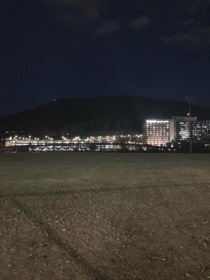 Recovering on the bleachers of the Reserve Park athletic fields. Carilion Hospital sits brightly in front of a darkened Mill Mountain. It’s full on night now. 