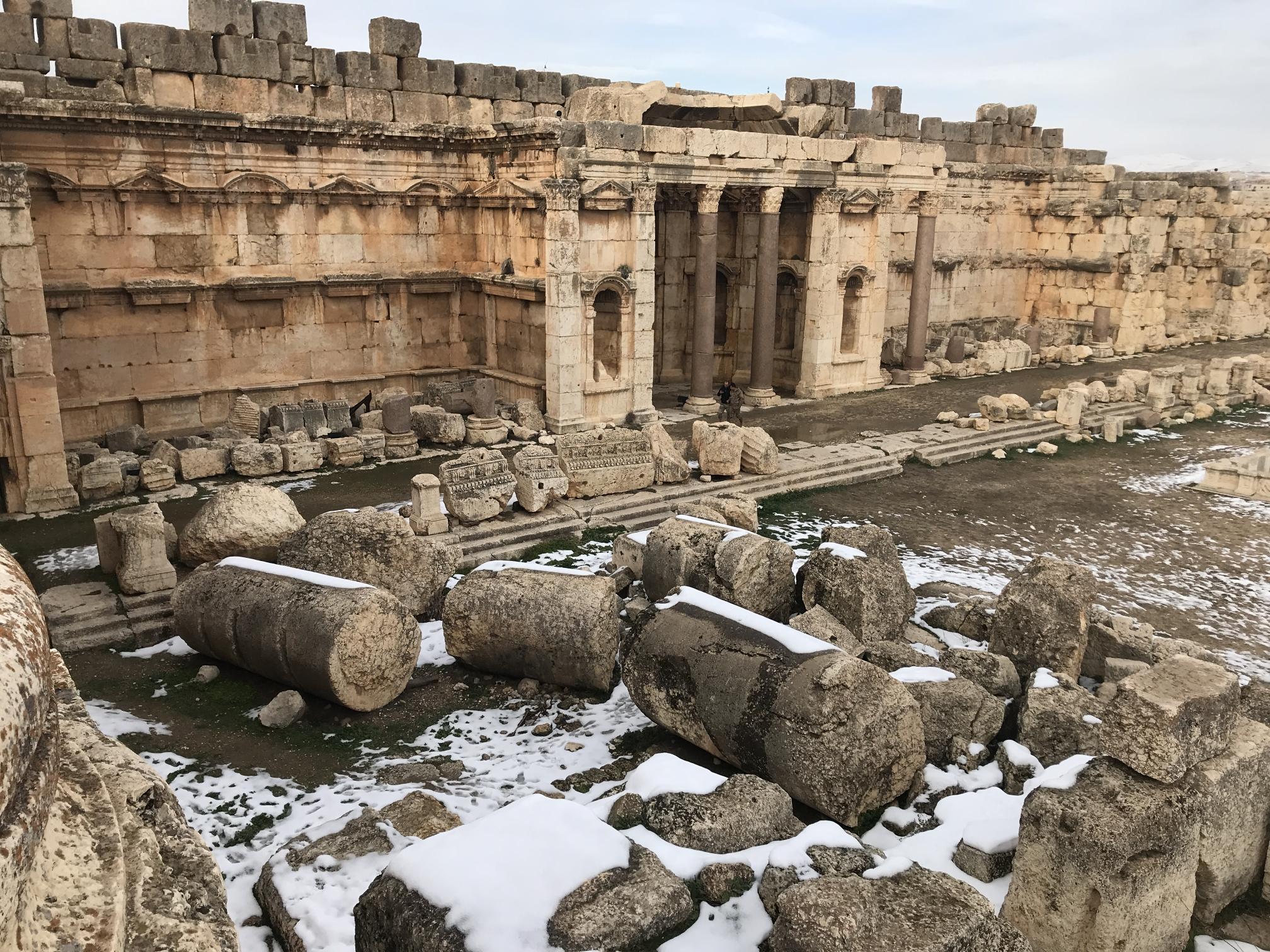 wall-temple in post above viewed from a 45 degree angle, showing remnants of fallen columns in the foreground.