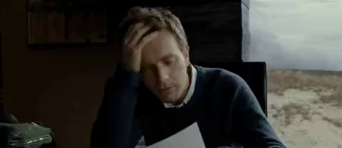 Ewan McGregor reads a letter, flips it down on the desk in disgust, and then emotes a very frustrated feeling with his hands up by his face and a silent scream.