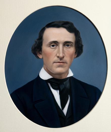 Headshot photograph of my paternal great-grandfather. A white man looking at the camera, with a high forehead and straight black hair parted on his right and combed to his left covering his ears. He’s wearing a dark suit and tie, and a white shirt with a high collar.
Photo retouched with Photoshop’s nano banana pro tool.