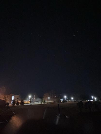 From the same spot at the end. It’s now pitch black outside. The high school building can be seen, sprawling out in every direction, lit by streetlights. Above, possibly, you might see the constellation Orion. 