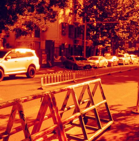 Harman Red 125 (6x6)

English Alt Text:
A quiet urban street lined with parked cars, including a white SUV in the foreground. Metal barricades are placed along the roadside, possibly for traffic control or construction. Trees and residential buildings line the street. The entire image is tinted with a strong orange-red filter, giving it a dramatic and surreal appearance. No people are visible, and the scene feels still and contemplative.
中文替代文字：
图像展示一条城市街道，路边停放着多辆汽车，前景是一辆白色SUV。金属护栏沿路摆放，可能用于交通管制…