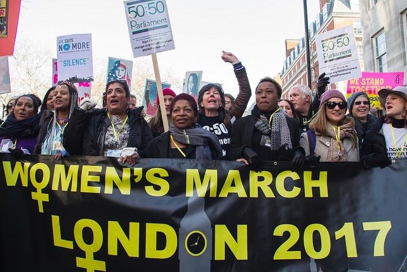 A photo of the London march. At the front black women are carrying a banner.
