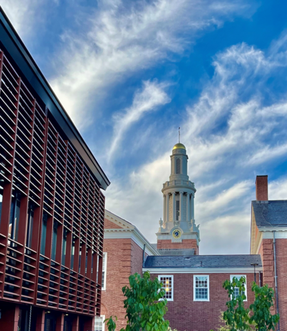 A modern building with a steeple in the background.
