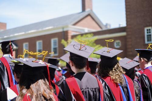 Graduating students with halos made out of pipe cleaners