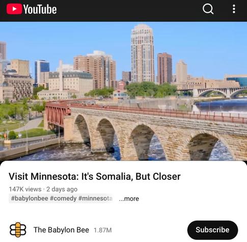 This is a screenshot of a YouTube video by The Babylon Bee, titled “Visit Minnesota: It's Somalia, But Closer” dated January 21, 2026. The picture shows a pedestrian bridge over a river leading to downtown Minneapolis.