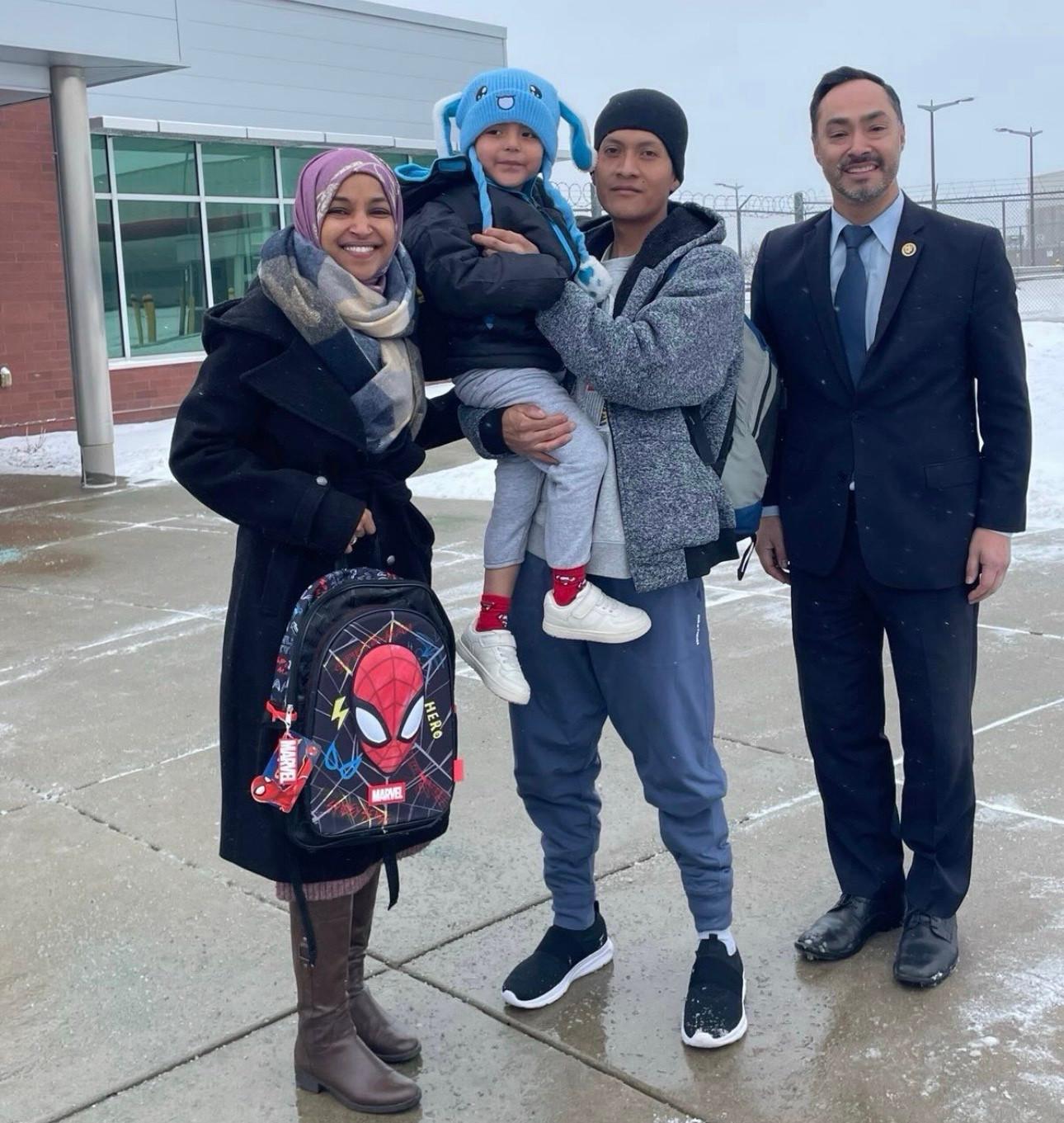 Liam Ramos and his dad outdoors with Ilhan Omar (holding the Spiderman backpack) and Joaquin Castro