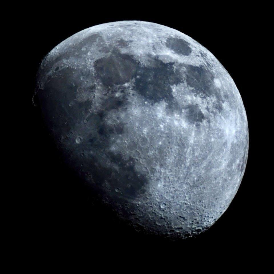 A photo of the moon where you can see some craters and topography.
