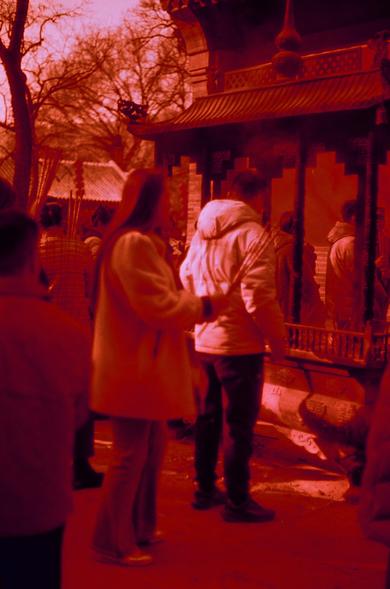 Harman Red 125 (FF)

English

A group of people is gathered in front of a traditional building with a red-tinted atmosphere. Two individuals in the foreground appear to be interacting, with one person facing the other. The building has a traditional architectural style with a tiled roof and ornate details. Trees are visible in the background.

中文

一群人聚集在一栋传统建筑前，整个场景被红色调覆盖。前景中有两个人看起来在互动，一个人面对着另一个人。建筑物具有传统的建筑风格，有瓦片屋顶和精美的细节。背景中可以看到树木。