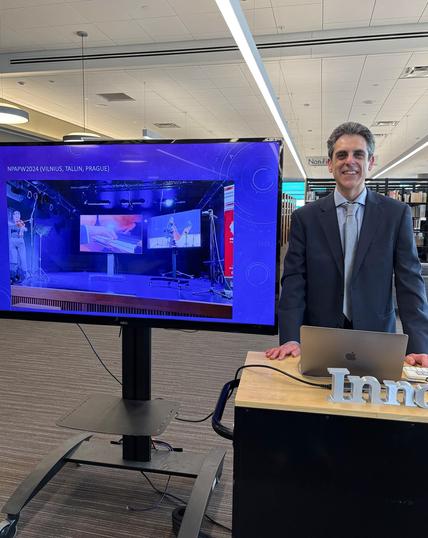 Man next to a screen