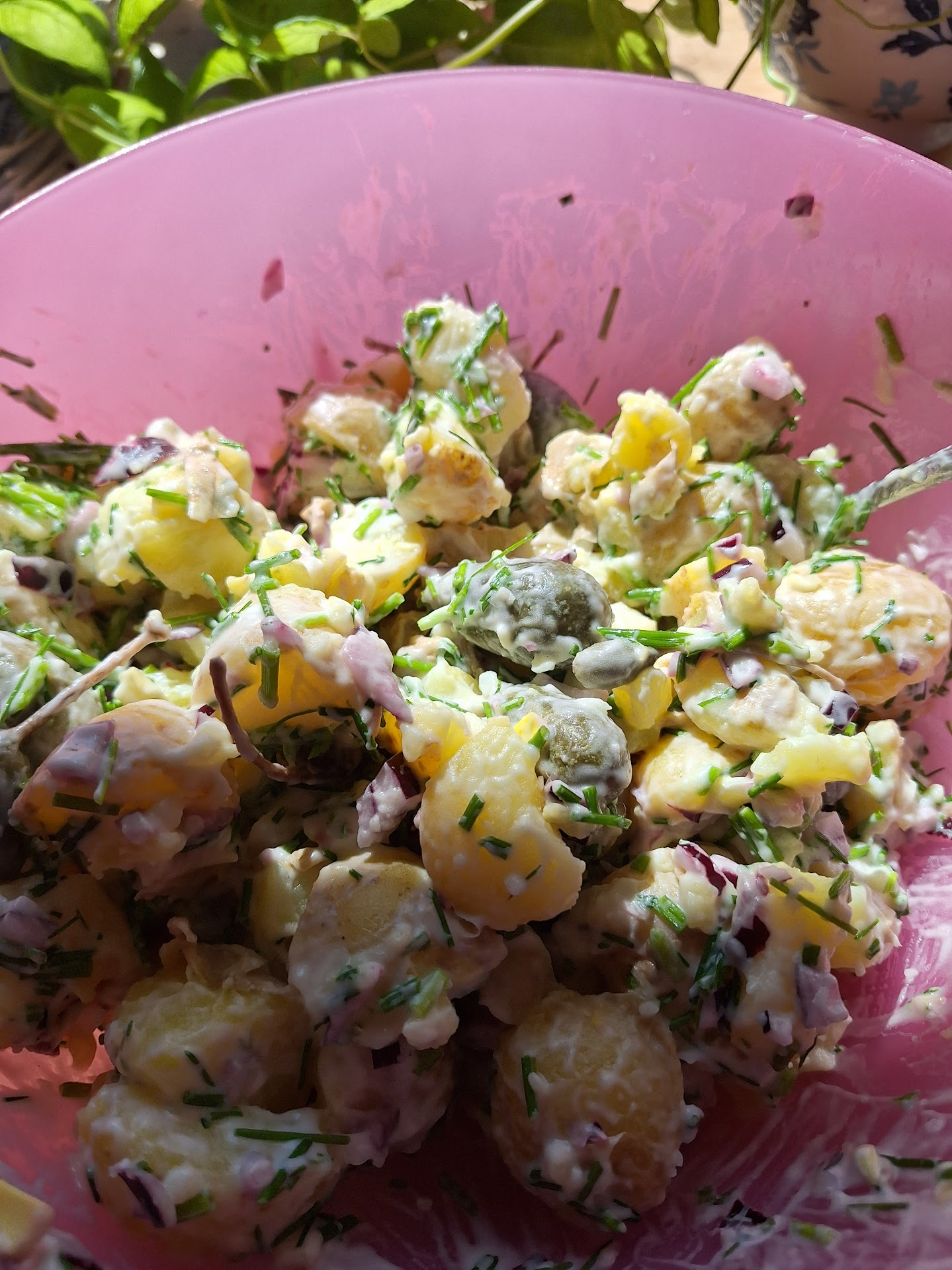 Potato salad in a pink bowl.