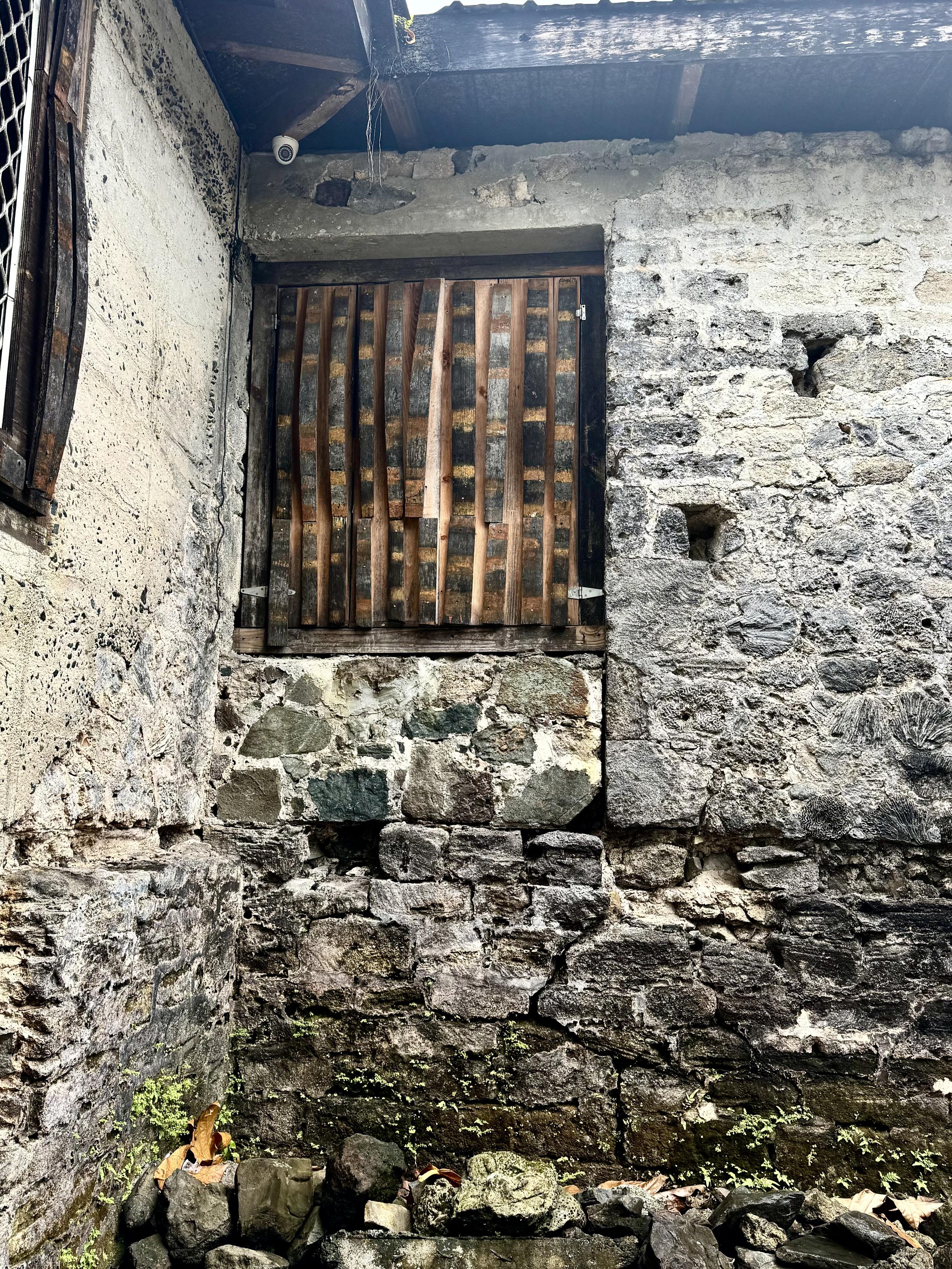 Photo of window on old stone structure. The window has strips of rum barrels lining the window vertically.

Callwood Rum Distillery, Cane Garden Bay, Tortolla, British Virgin Islands.