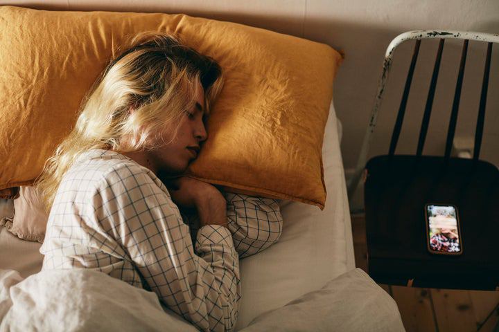 A person sleeping with their wrists bent back toward their body
