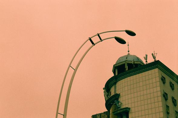 Harman Switch Azure (FF)

English
A close-up of a curved street lamp post with two lantern-style lights. The background features a domed building with a tiled facade and several antennas on its roof. The sky is a soft pinkish-orange
中文
弯曲的路灯杆特写，杆上有两盏灯笼式灯具。背景是一个圆顶建筑，外墙贴有瓷砖，屋顶上有多个天线。天空呈柔和的粉红橙色。