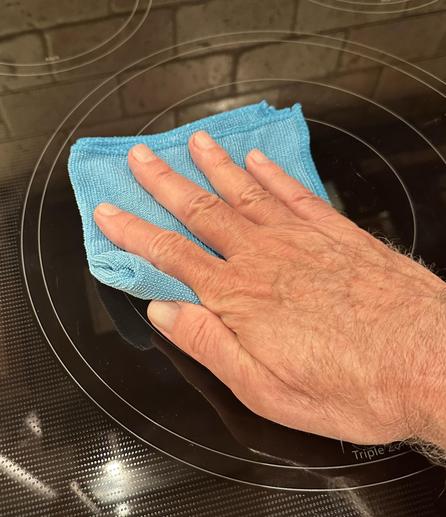 Photo of the back of a white male’s hand (my very own, again) pressing down on a pad wiping down a stovetop. All fingers are extended, and I can press evenly on all of them. No pain.