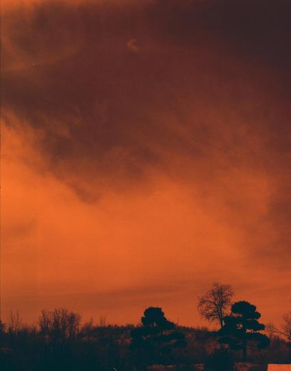 Harman Red 125 (6x7)

##English
A dark, dramatic sky with thick, swirling orange and red clouds. The horizon is lined with the silhouettes of trees, their bare branches creating a stark contrast against the vibrant, almost fiery sky.
##中文
浓厚的橙红色云层在天空中翻滚，营造出戏剧性的氛围。地平线上排列着树木的剪影，光秃的树枝与充满活力的、几乎像火焰般的天空形成鲜明对比。