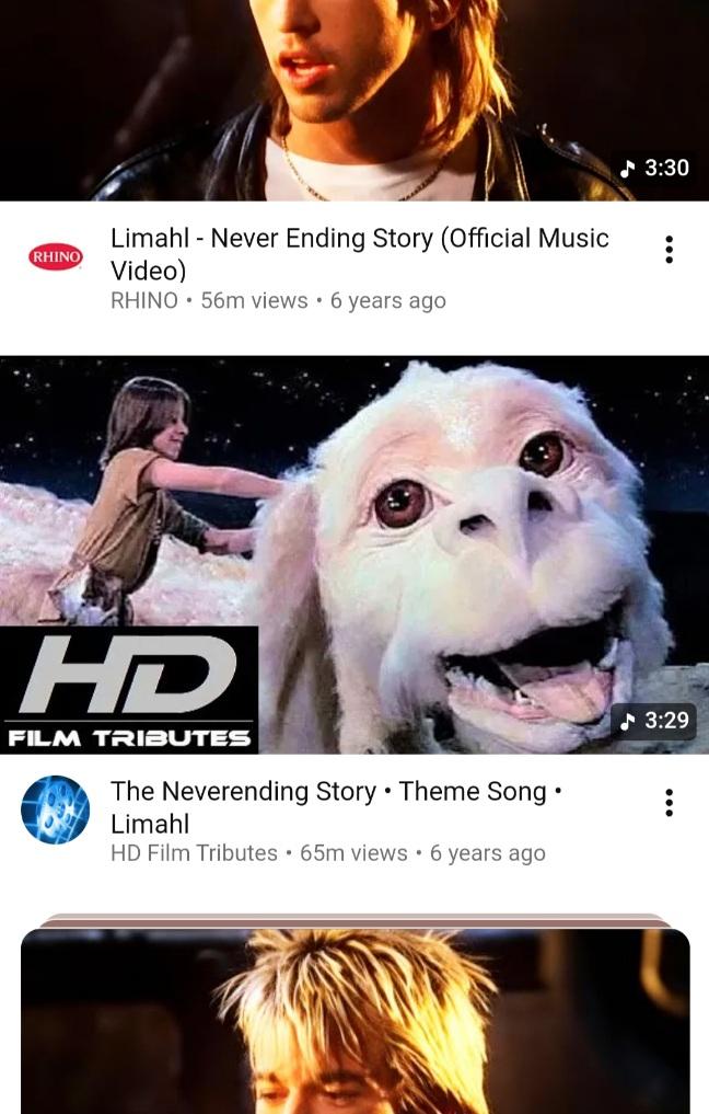 A screenshot from a not only children movie/film called "The Neverending Story" with a small preview picture of Atreju helping Falkon (Fuchur in German), the white dragon. The video is in HD quality with the suitable sign in the lower left corner of the picture. Above and below of the picture are preview photos with cutted photos of Limahl's head. The one above shows his nose to chin, the one below shows his head to nose. All three have clickoptions to links, if this wouldn't be a picture.