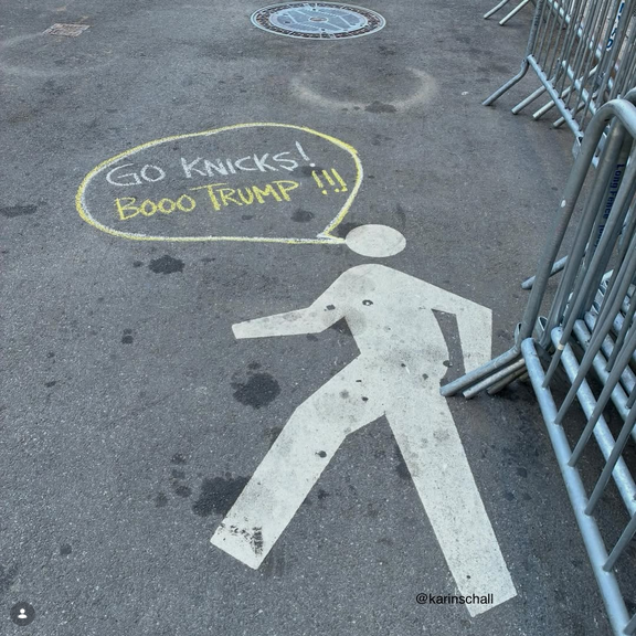 Picture posted on Ig by Rise and Resist NYC. They've been out chalking the sidewalks and streets of NYC ahead of Trump ruining the Knicks' historic game for everyone. A "walk" outline on the street has a chalk speech bubble saying "GO KNICKS! BOOOOO TRUMP!!!"
