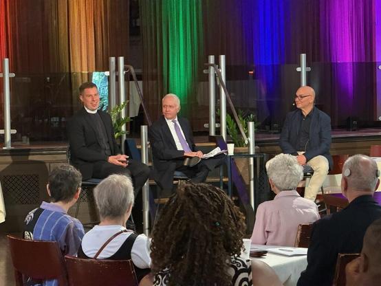 Three people on a discussion panel.