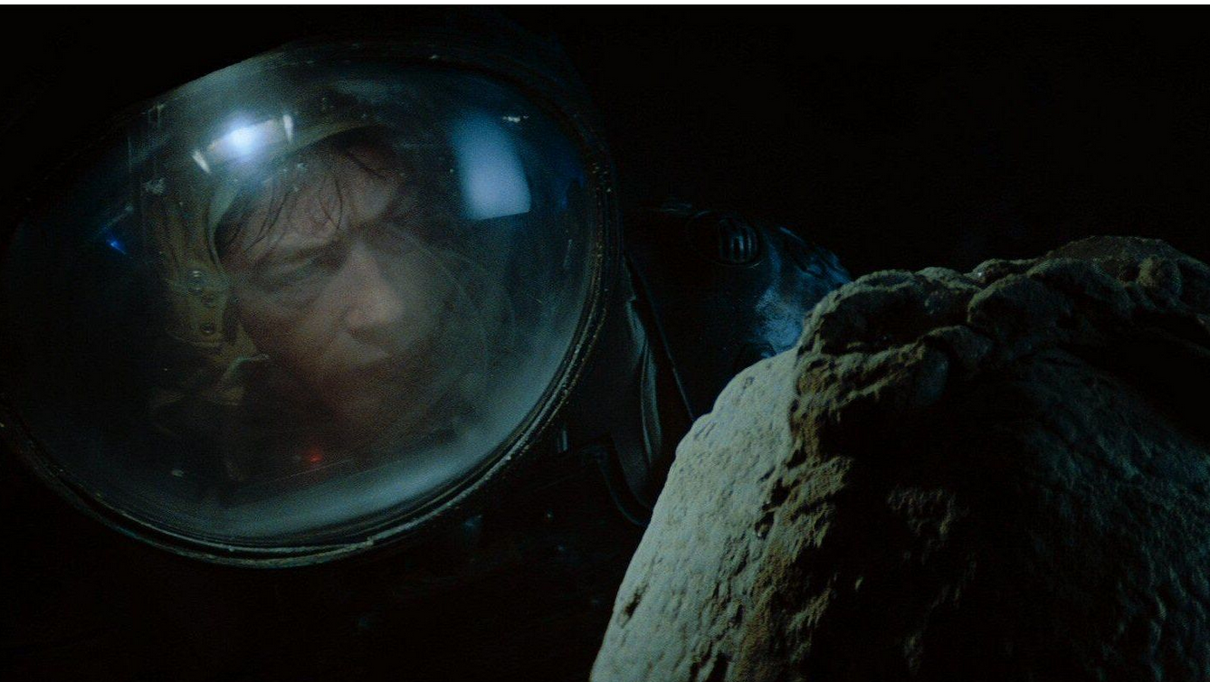 Kane (John Hurt) from "Alien" (the first movie) in a pressure suit investigates a xenomorph's egg.